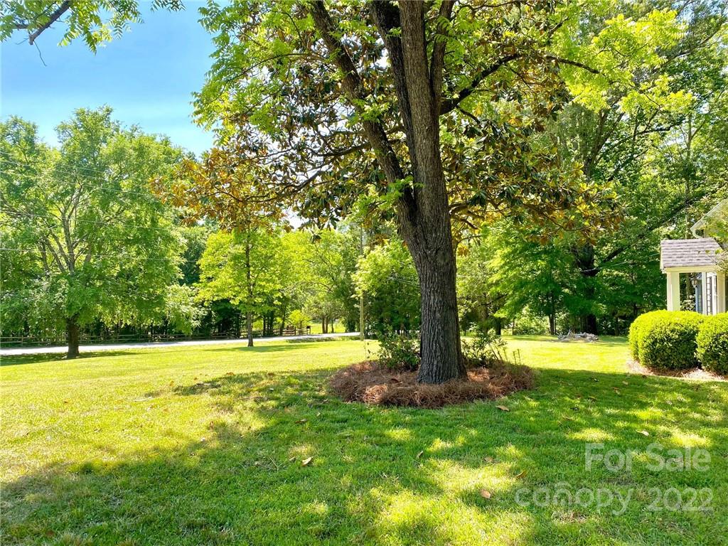 9425 Robinson Church Road Charlotte, NC 28215 - Photo 10 of 34 a view of a playground with a tree and a yard