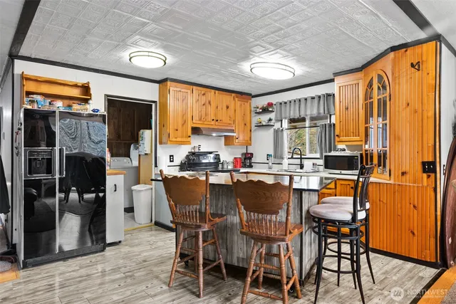 a kitchen with stainless steel appliances granite countertop a sink and cabinets