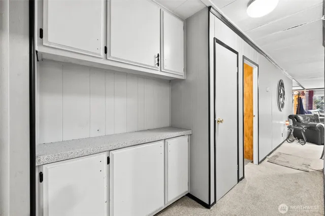 a living room with furniture a couch and large window