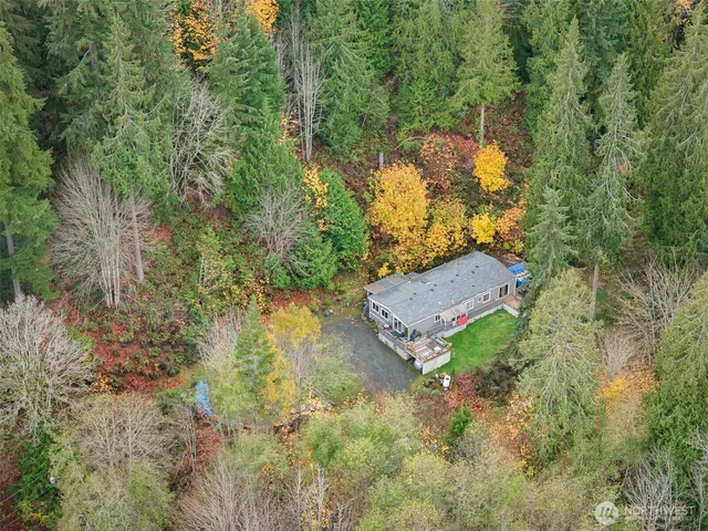 an aerial view of a house with a yard
