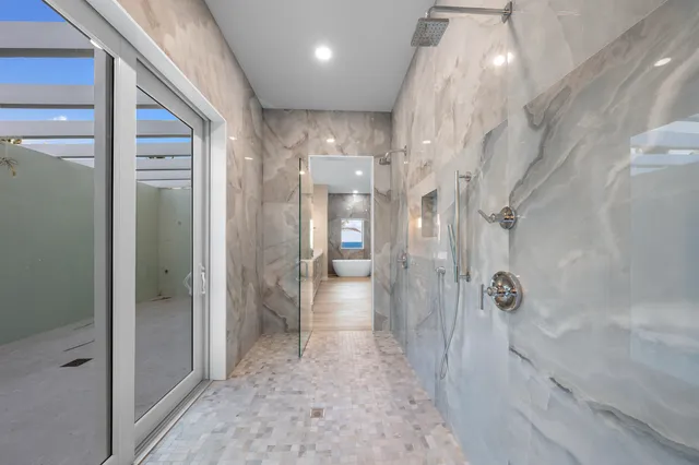a bathroom with a glass door shower