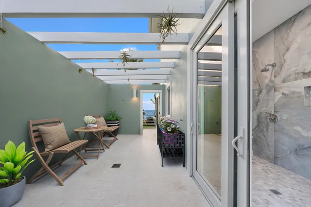 a lobby with furniture and a potted plant