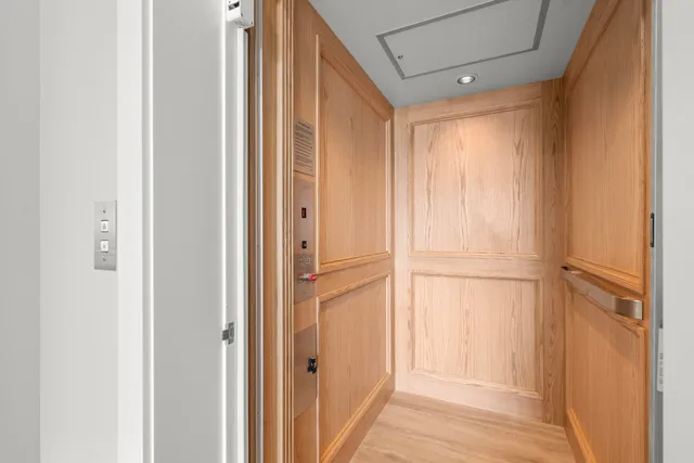 a view of a room with wooden floor