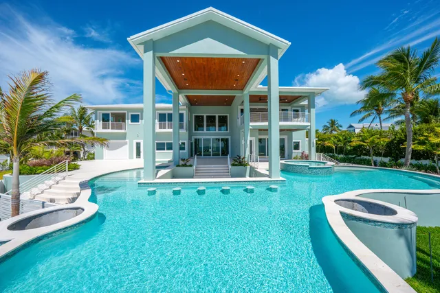 a view of a house with a backyard patio and swimming pool