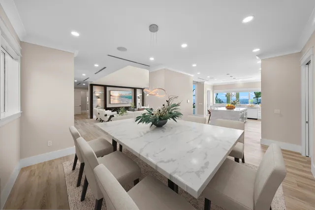 a dining room with furniture and a potted plant