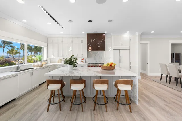 a kitchen with granite countertop sink cabinets and wooden floor