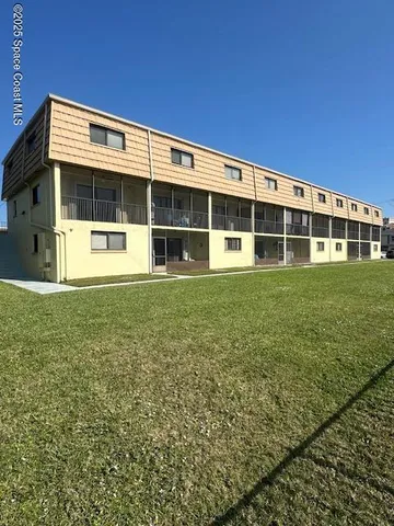 a large building with a big yard and large trees