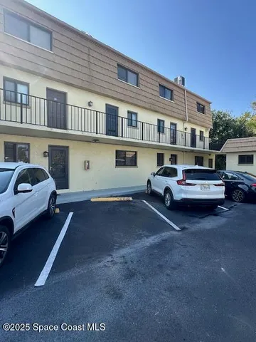a couple of cars parked in front of a house