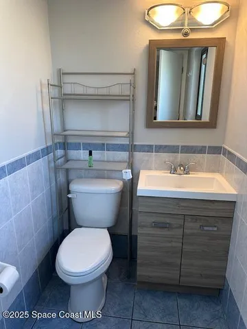 a bathroom with a sink toilet and mirror