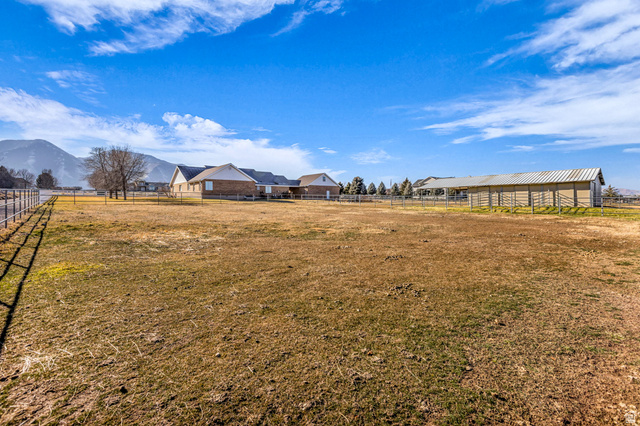 1060 West 2620th Street South Mapleton, UT 84664 - Photo 75 of 87 View of yard featuring a mountain view and an outdoor structure