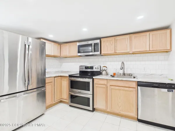 a kitchen with granite countertop white cabinets and white appliances