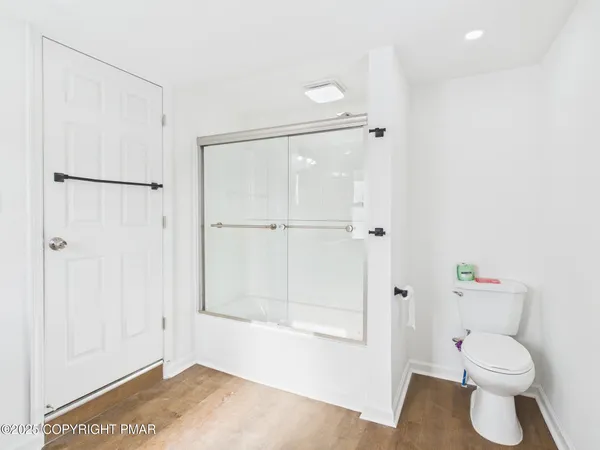 a bathroom with a toilet a sink and shower