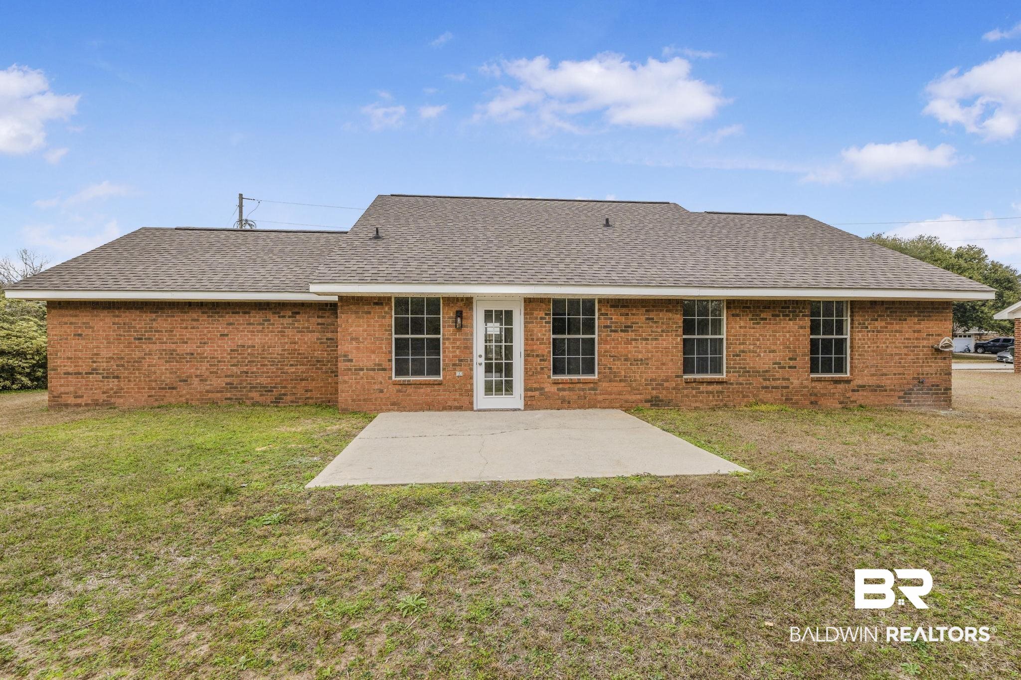 16330 Absalom Street Foley, AL 36535 - Photo 10 of 42 Rear view of house with a patio area and a lawn