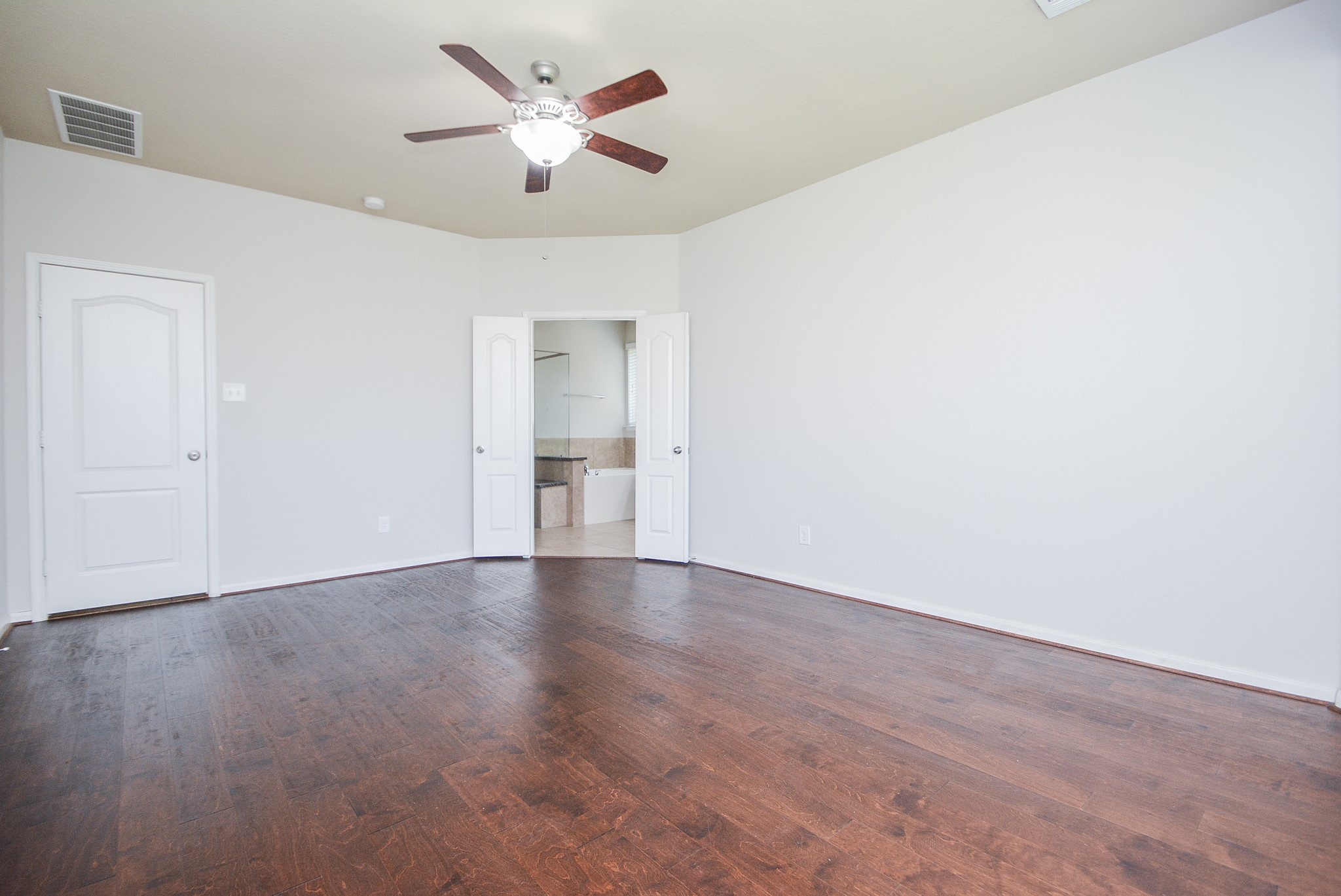 7418 Wilson Reach Lane Spring, TX 77389 - Photo 13 of 32 Primary bedroom features high ceilings and hardwood flooring