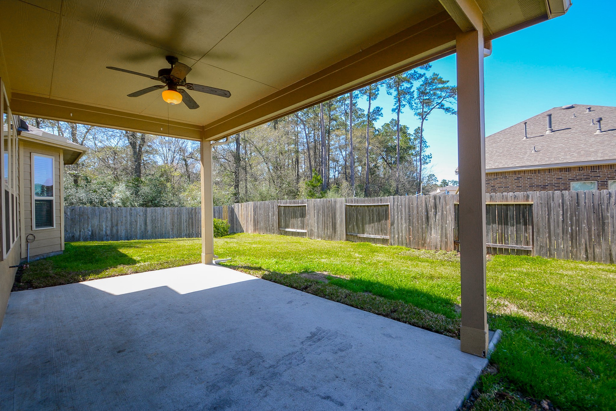 7418 Wilson Reach Lane Spring, TX 77389 - Photo 30 of 32 Covered patio features ceiling fan to cool you down during summer heat.