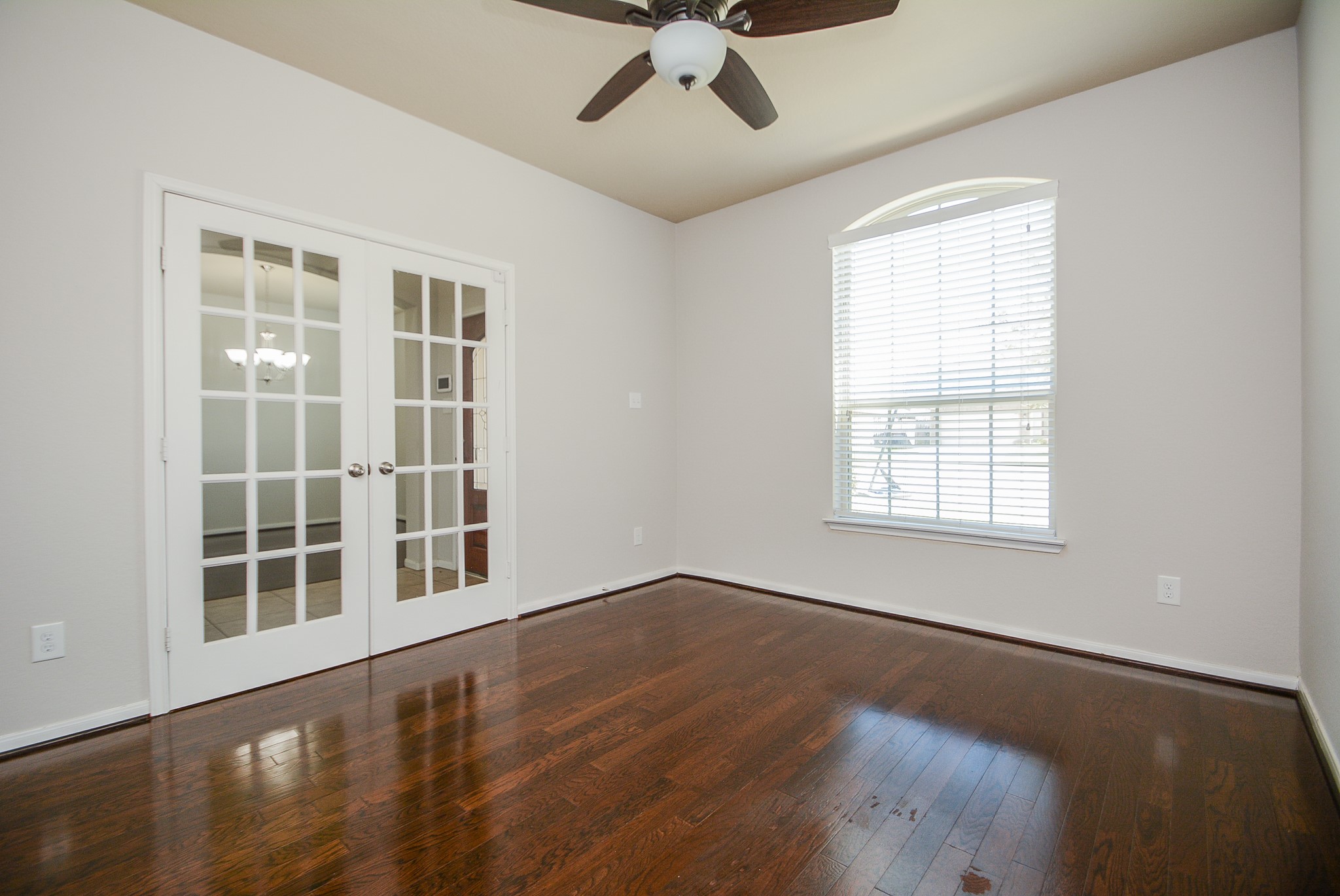 7418 Wilson Reach Lane Spring, TX 77389 - Photo 6 of 32 Study room features french doors, hardwood flooring and ceiling fan.