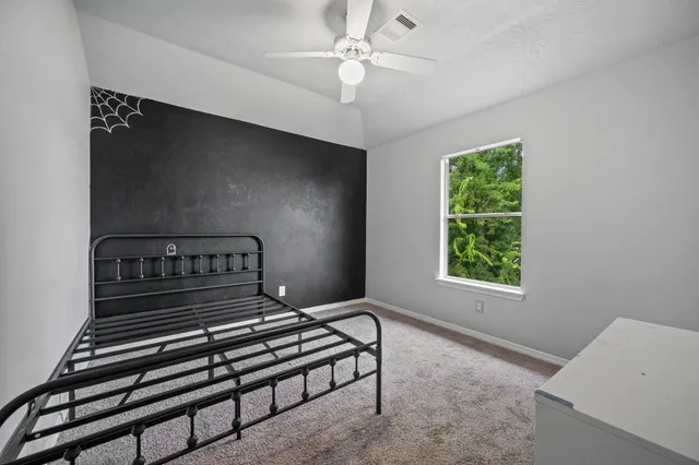 a bedroom with furniture and a window