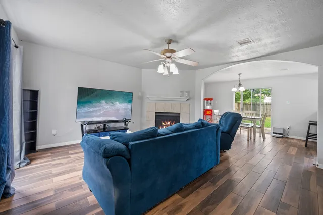 a living room with furniture a fireplace and a flat screen tv