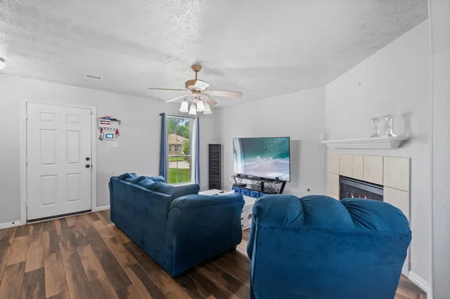 a living room with furniture a chandelier and a flat screen tv