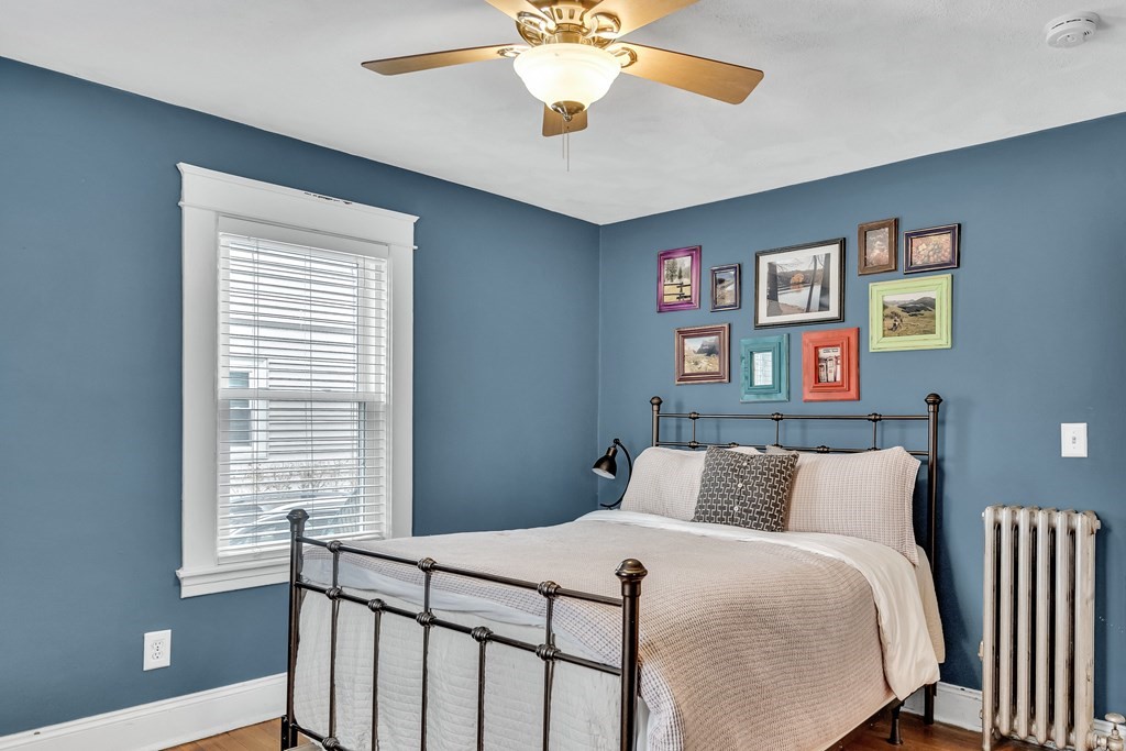 63-65 Brookley Road, Unit 1 Boston, MA 02130 - Photo 11 of 20 a bedroom with a bed and a chandelier
