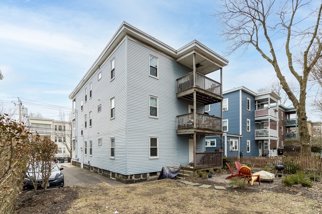 63-65 Brookley Road, Unit 1 Boston, MA 02130 - Photo 17 of 20 a view of a house with a yard