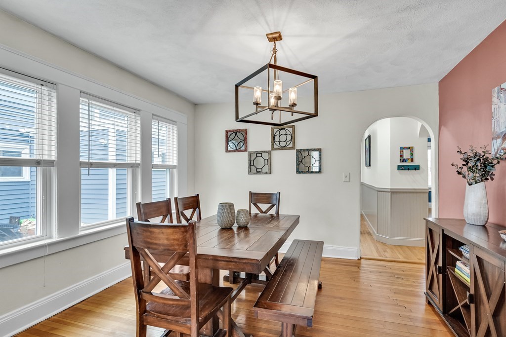 63-65 Brookley Road, Unit 1 Boston, MA 02130 - Photo 5 of 20 a view of a dining room with furniture a chandelier and wooden floor
