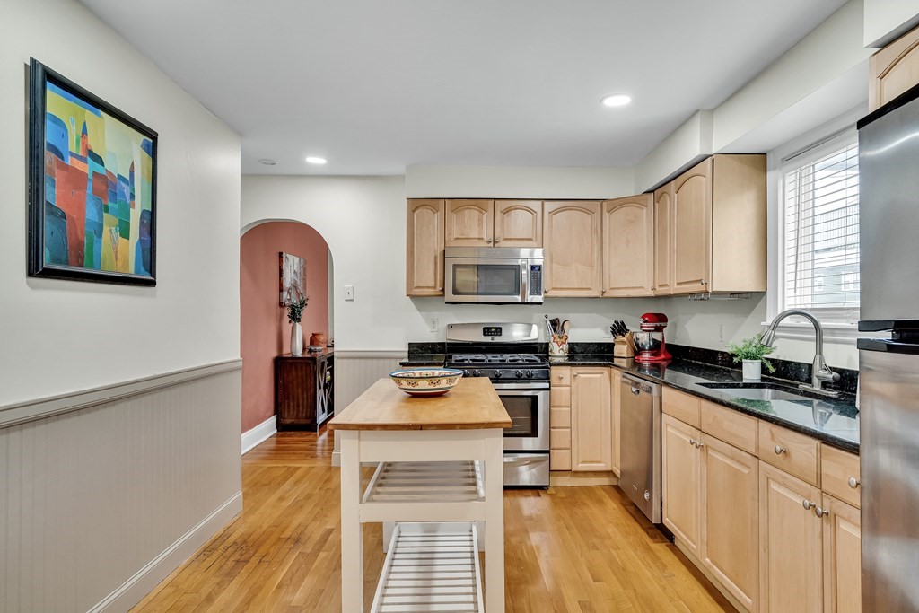 63-65 Brookley Road, Unit 1 Boston, MA 02130 - Photo 9 of 20 a kitchen with stainless steel appliances a stove refrigerator sink and cabinets