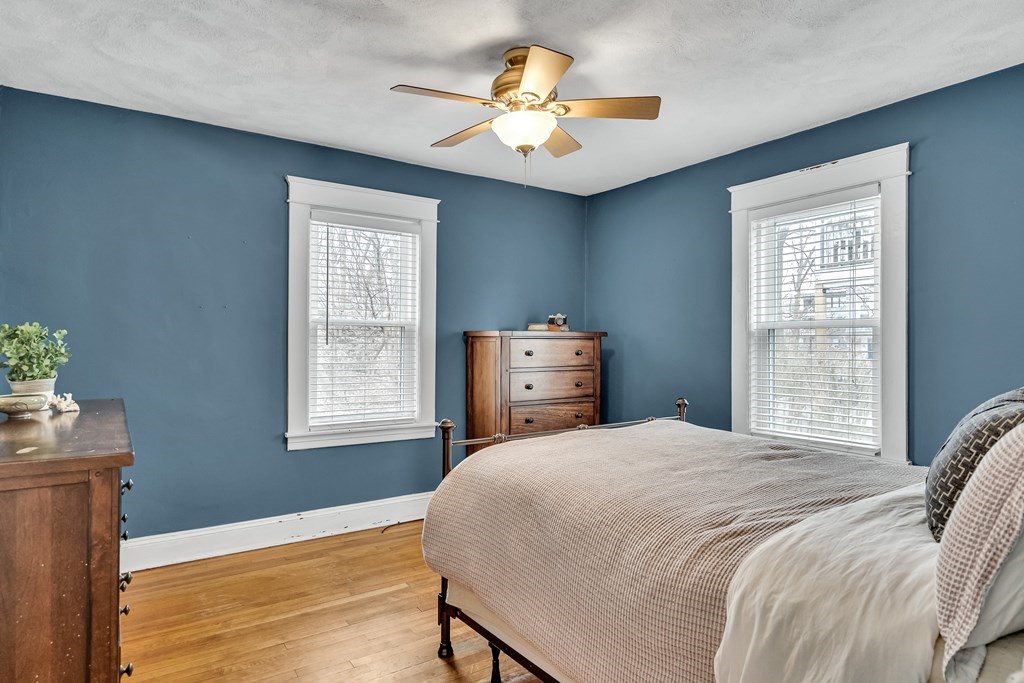 63-65 Brookley Road, Unit 1 Boston, MA 02130 - Photo 10 of 20 a bedroom with a bed and a chandelier