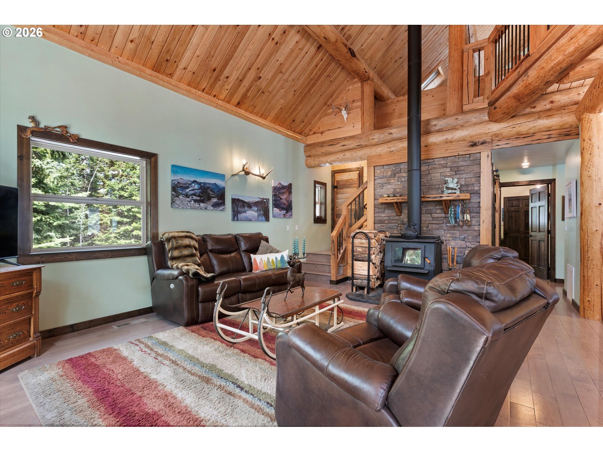 60989 Old Ski Run Road Joseph, OR 97846 - Photo 12 of 46 a living room with furniture a large window and a rug