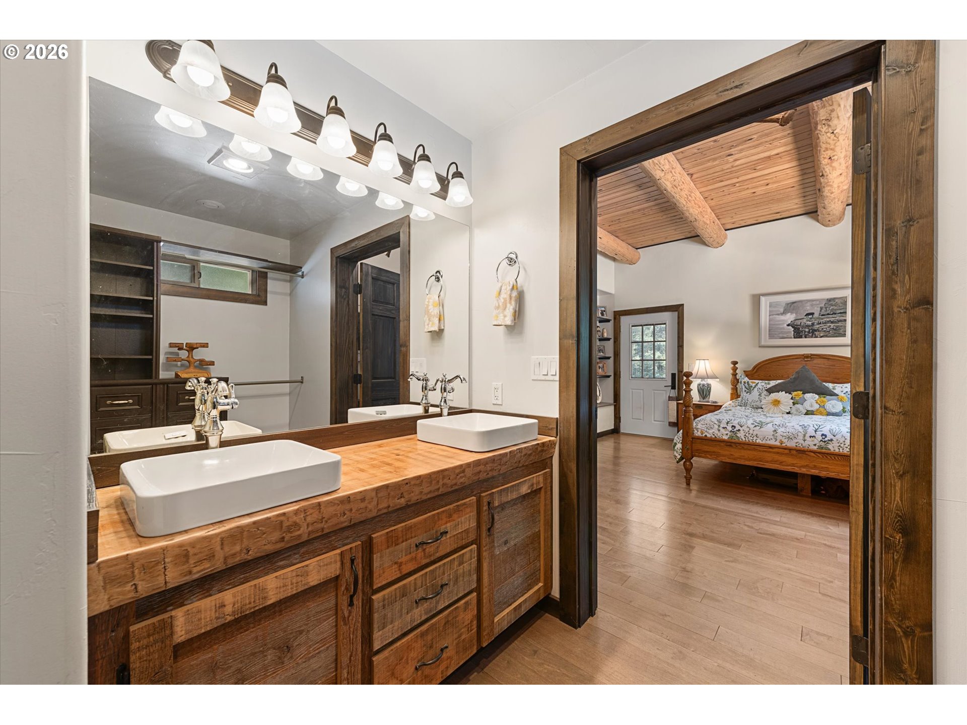 60989 Old Ski Run Road Joseph, OR 97846 - Photo 20 of 46 a en suite bathroom with a granite countertop sink and a large mirror
