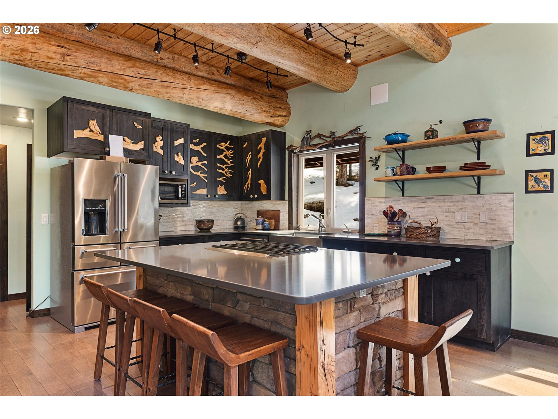 60989 Old Ski Run Road Joseph, OR 97846 - Photo 5 of 46 a kitchen with stainless steel appliances granite countertop a stove a sink and a refrigerator