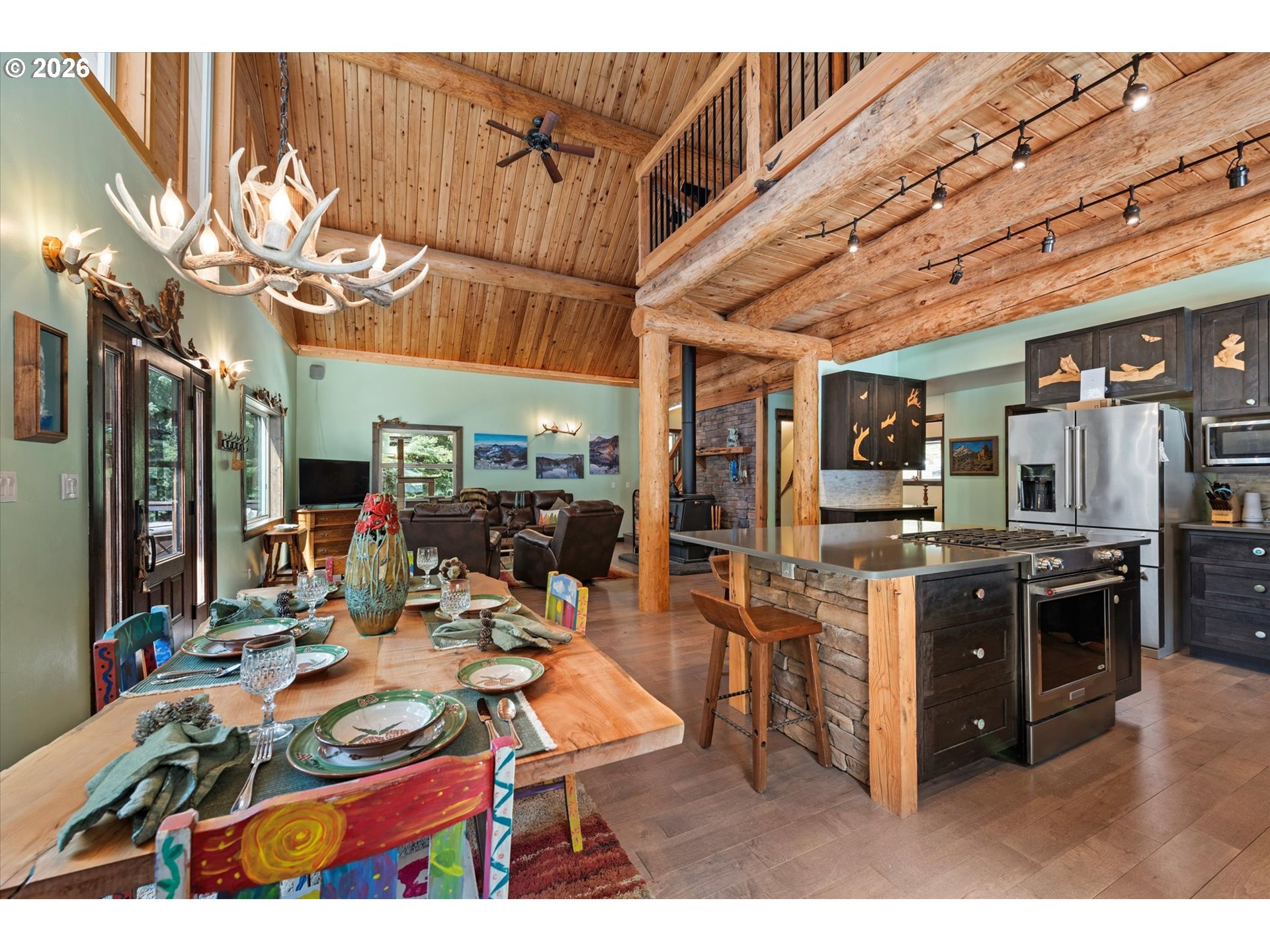 60989 Old Ski Run Road Joseph, OR 97846 - Photo 10 of 46 a living room with stainless steel appliances kitchen island granite countertop lots of clutter