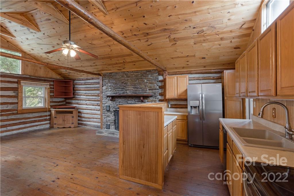 242 Colony Road Hendersonville, NC 28792 - Photo 7 of 14 a view of a refrigerator in kitchen and wooden floor