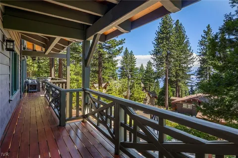 a view of balcony with chairs and wooden floor