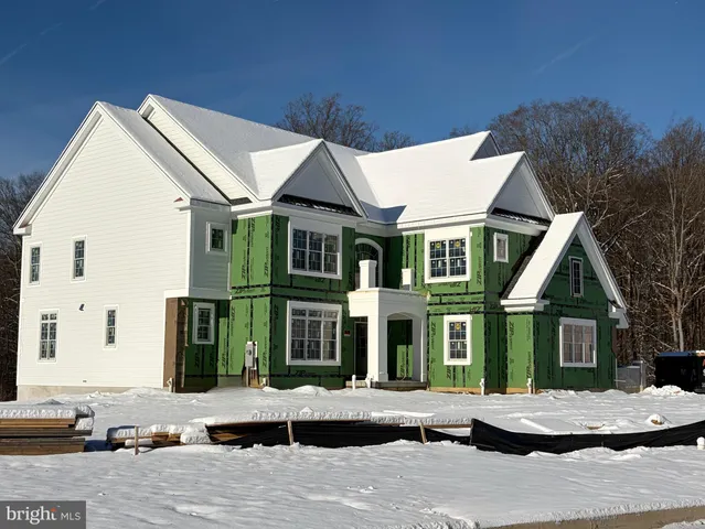 a view of a white house with large windows