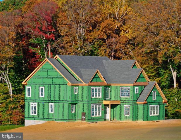 a view of house with a yard and potted plants