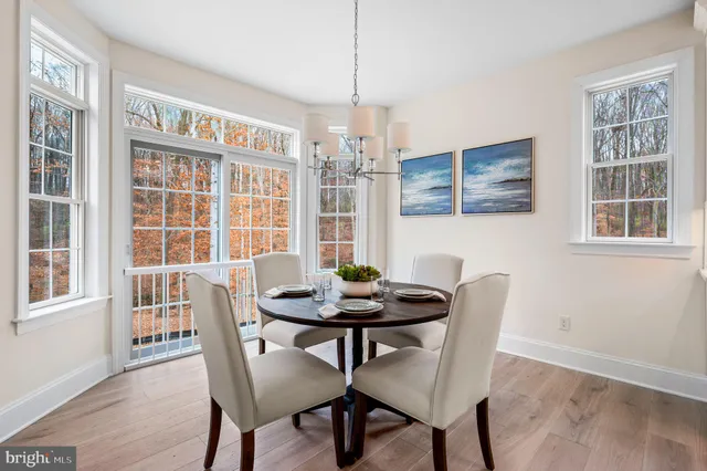 a dining room with furniture wooden floor and a chandelier
