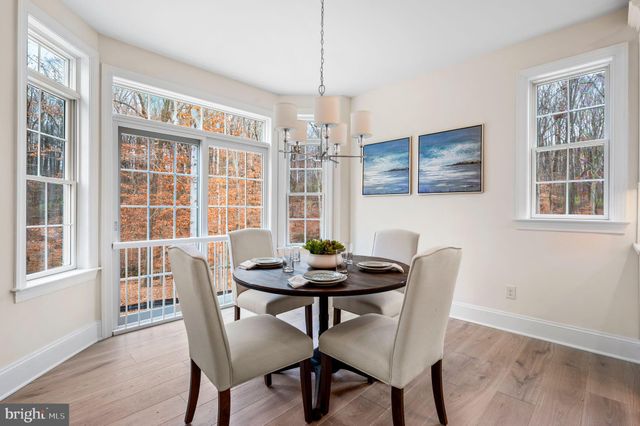 a dining room with furniture wooden floor and a chandelier