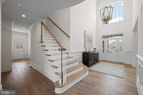 a view of entryway and hall with wooden floor