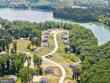 an aerial view of a house with a lake view