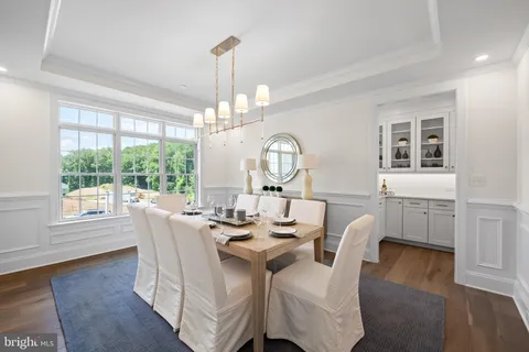 a view of a dining room with furniture wooden floor and chandelier