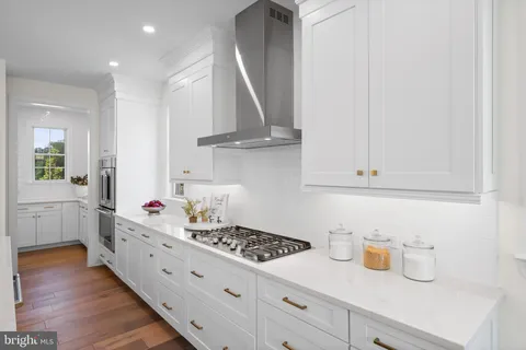 a kitchen with cabinets and a stove top oven