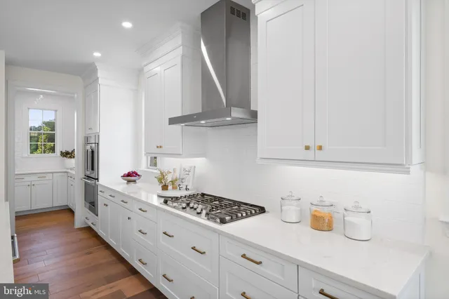 a kitchen with cabinets and a stove top oven