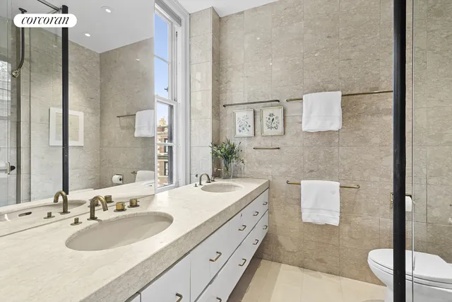 a spacious bedroom with a bed and glass door