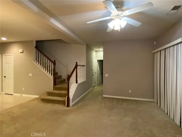 a view of entryway and hall with a chandelier fan