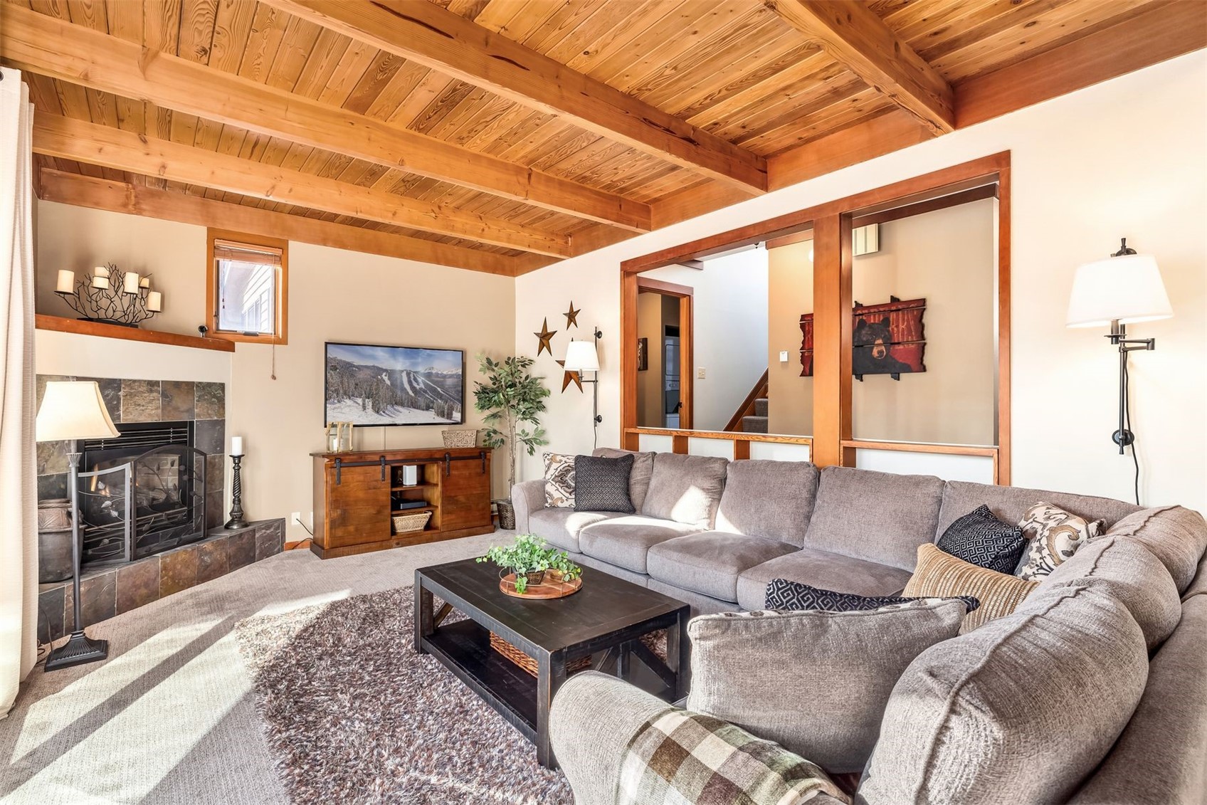 410 Tennis Club Road, Unit 1317 Keystone, CO 80435 - Photo 20 of 42 a living room with furniture a fireplace and a flat screen tv