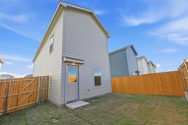 a view of a house with wooden fence
