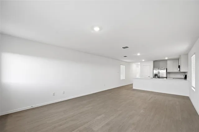 an empty room with a kitchen and a sink