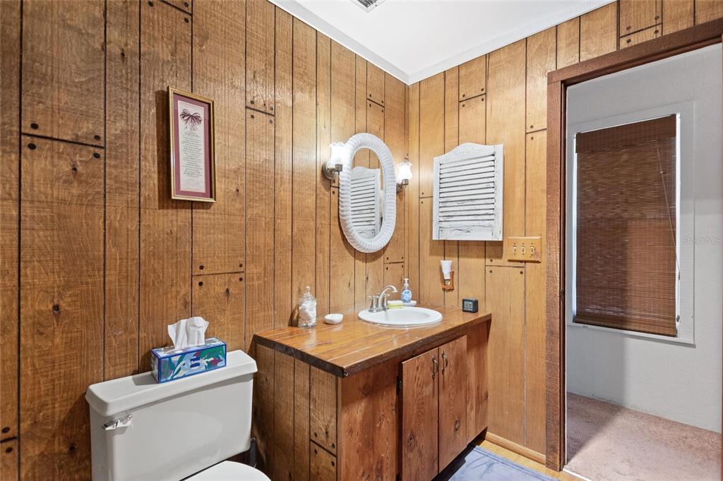 3641 Turtle Mound Road Melbourne, FL 32934 - Photo 35 of 77 a bathroom with a sink and a mirror