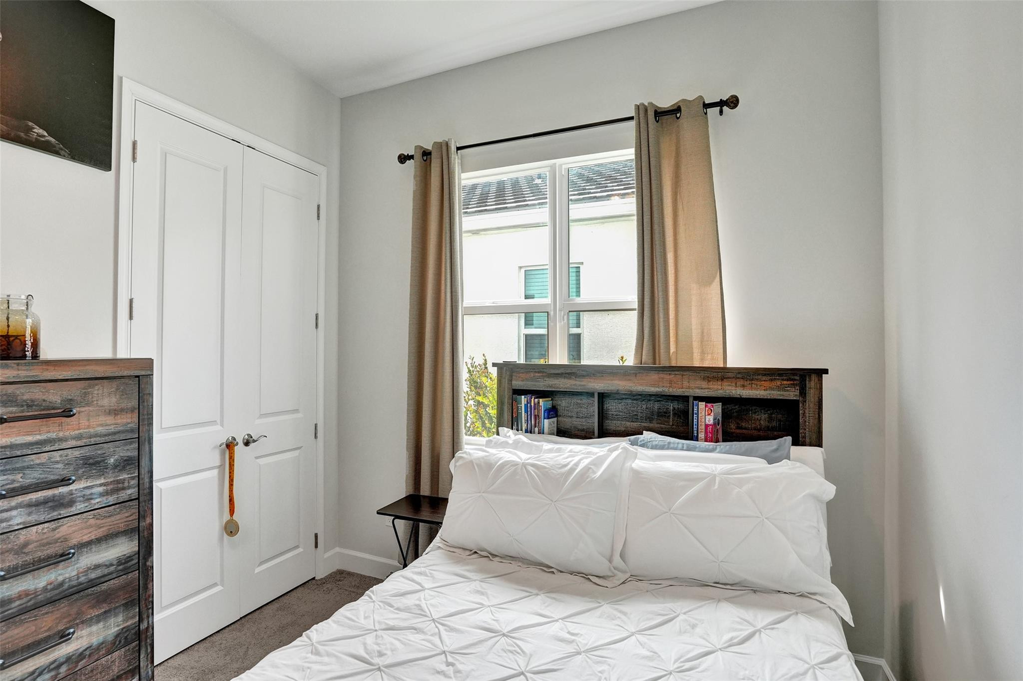 5416 Macoon Way Loxahatchee, FL 33470 - Photo 18 of 43 a bedroom with a large bed and a window